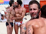 Love is in the air! Marc Jacobs and porn star beau Harry Louis show off their buff bodies in tiny swimshorts as they canoodle on the beach