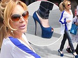 Adrienne Maloof saunters in comically high blue heels as she treats her twin sons to fast food on their birthday