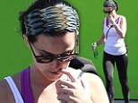 Time for a bite? Katy Perry chews her nails as she heads for a workout in wake of lawsuit drama
