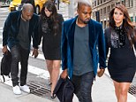 Her hero! Kanye West steers Kim Kardashian over a drain as she steps out in another little black dress with killer heels 