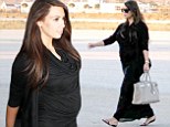 A bumpy ride! Pregnant Kim Kardashian reveals her VERY burgeoning belly in a sheer maxi dress as she touches down in Greece with her family