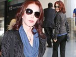 Turning back the hands of time: Priscilla Presley showcases her youthful good looks as she struts through LAX in low-key leather