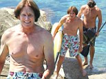 Former gold medalist Bruce Jenner, 63, shows off a more wrinklier physique as he goes paddle boarding with muscular sons Brandon and Brody 
