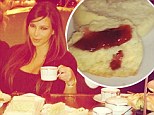 Kim Kardashian treats herself (and bump) to high tea as she gobbles down scones and jam after arriving in London