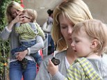 Sunglass inspector: January Jones held one-year-old son Xander on Wednesday as he examined her shades