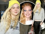 Back to bare! Makeup-free Elle Fanning touches down at LAX after stepping out in dramatic eyeshadow for 2013 Met Ball