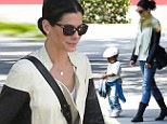 Easy rider! Sandra Bullock sweetly cradles son Louis while clad in a leather jacket and motorcycle boots