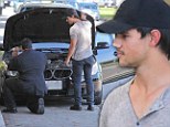 Taylor Lautner gets a jump start from a valet service after his car fails outside fancy hotel