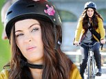 Megan Fox puts on a pouty face as wears a boxy helmet while riding through the streets of New York on the set of Teenage Mutant Ninja Turtles