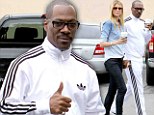 They must adore each other... and coffee: Eddie Murphy mugs for cameras with model girlfriend Paige Butcher on their daily java run