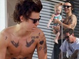 Harry Styles reveals the full extent of his tattoo obsession as he displays his inked up torso by going shirtless in Barcelona