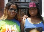 Makia Underwood, left, and sister Zakia Clark, along with their uncle Curran Underwood, right, wear their anti-cancer gear in Philadelphia, on May 21