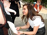 Touchy-feely: The actress got to grips with a young baby at the gathering