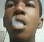 Photos: New photos, including above, from Trayvon Martin's cell phone shows the slain Florida teenager blowing smoke rings, a gun and what appears to be a marijuana plant