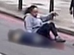 The angel of Woolwich: A woman sits next to the dead soldier after the brutal killing while two other women calm the situation