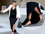 Not the smartest choice! Heavily pregnant Kim Kardashian tries to stay composed as she awkwardly stumbles over own dress 