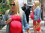 Counting down the days! Busy Philipps displays her HUGE baby bump in a fitted red dress as her due date looms