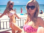 She's a working girl! Paris Hilton is a 'proud designer' as she struts her stuff in a bikini on a Hawaiian beach during a campaign for her new clothing line