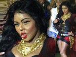 That's one way to make a pout! Lil' Kim looks stony faced as she flashes a peace sign and some major cleavage while taking pictures with fans