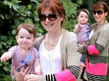 Smiles to match! Alyson Hannigan and her baby daughter beam as they take a stroll in evergreen Los Angeles