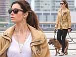 Dog day afternoon: Jessica Biel takes dogs for a walk along the Hudson wearing a stylish beige parka