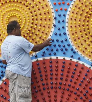 A man counts bulbs to be decorated with illuminated panels showing episodes from Buddha's life, ahead of Vesak Day celebrations in Colombo, Sri Lanka
