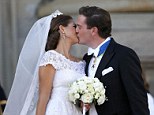 Sealed with a kiss: Princess Madeleine of Sweden kisses her new husband, British-born financier Chris O'Neill, following their lavish wedding ceremony in Stockholm today
