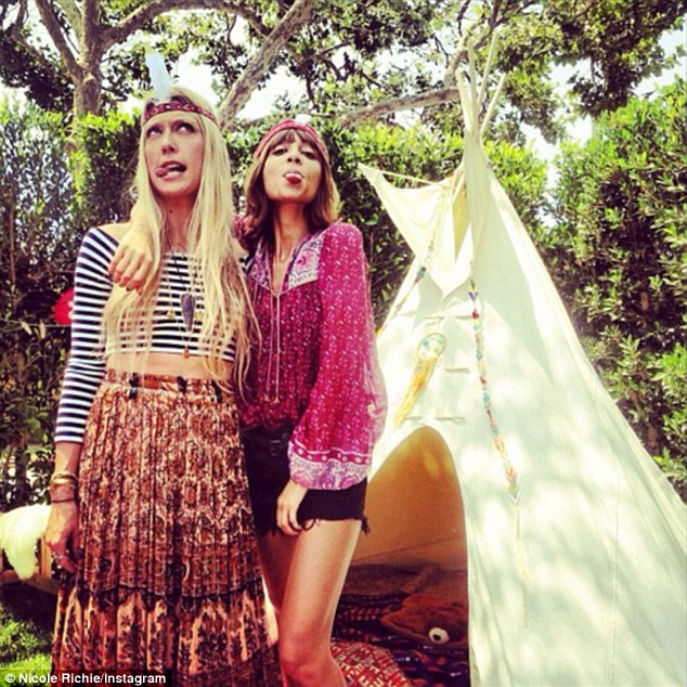 'Another Saturday Night': Nicole Richie posted an Instagram snap of herself Saturday wearing a feather headband in front of teepee alongside a gal pal for some sort of 'pow wow'