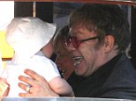 Doting dad: Sir Elton John kept his four-month-old son Elijah entertained by pulling a variety of funny faces during a boat trip in Venice, Italy, on Friday