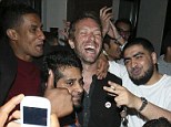 Say cheese: Chris Martin smiles for the many cameraphones with his fans outside Cafe de Paris in London