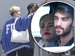 Rough and tumble girl! Miley Cyrus dons varsity jacket emblazoned with offensive acronym as she heads to recording studio