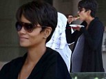 Eating for two! Pregnant Halle Berry nourishes her growing baby bump as she snacks while partying with friends 
