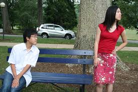 funny image of young guy trying to talk to young woman