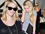 Going dotty: Reese Witherspoon cuts a striking figure in spotted trousers as she arrives at LAX with her lookalike daughter Ava