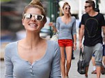 Jessica Hart parades her toned legs in tiny orange shorts during city stroll with friends 