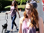 Peep show: Kristen Stewart flashes her bra in low cut vest as she takes her new pet pooch out to lunch 