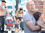 Daddy duty: Bruce Willis and his wife Emma Heming change their baby daughter Mabel in Los Angeles