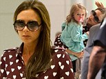 Victoria Beckham wears her heart on her sleeve in patterned dress shirt while carrying Harper through JFK