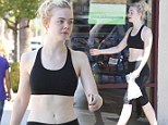 She earned it! Elle Fanning treats herself to a Subway sandwich while showing off her flat stomach in workout wear
