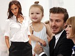Mummy's lucky mascot! Harper Beckham sits on David's lap front row at Victoria's New York Fashion Week show