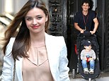 That's a little more ladylike! Miranda Kerr covers up from head-to-toe to go to the tennis with her parents after overexposing herself on the red carpet