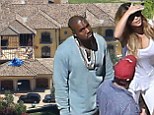 New mother Kim Kardashian shows off her slim figure in all-white outfit as she joins Kanye West to inspect construction on their $11m Bel Air mansion