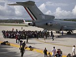Escape: Hundreds of stranded tourists queue to board a Mexican Air Force jet after landslides caused by Tropical Storm Manuel cut off roads to the holiday resort of Acapulco