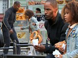 Life isn't that tough for orphan Annie as Jamie Foxx and co-star Quvenzhane Wallis bond over pretzels and football on the set