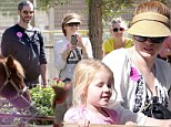 Getting into the Halloween spirit early! Amy Adams carves out some holiday fun at pumpkin patch with fiance and daughter