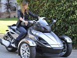 Tomboy Stacy Keibler proves that three wheels are better than two when she hits the road on a Can-Am Spyder motorbike