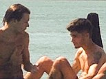 Stripping off: The One Direction heartthrobs relax on the stunning Qualia resort on the northern most tip of Hamilton Island 