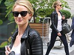 Striding up a storm! Rosie Huntington-Whiteley is runway ready in leg-lengthening jeans and fierce boots
