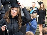 Elizabeth Hurley perches on a step as she films scenes for new show The Royals