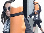 Why so shy? Demi Moore hid behind her orange yoga mat as she left a class in Hollywood, California on Thursday
